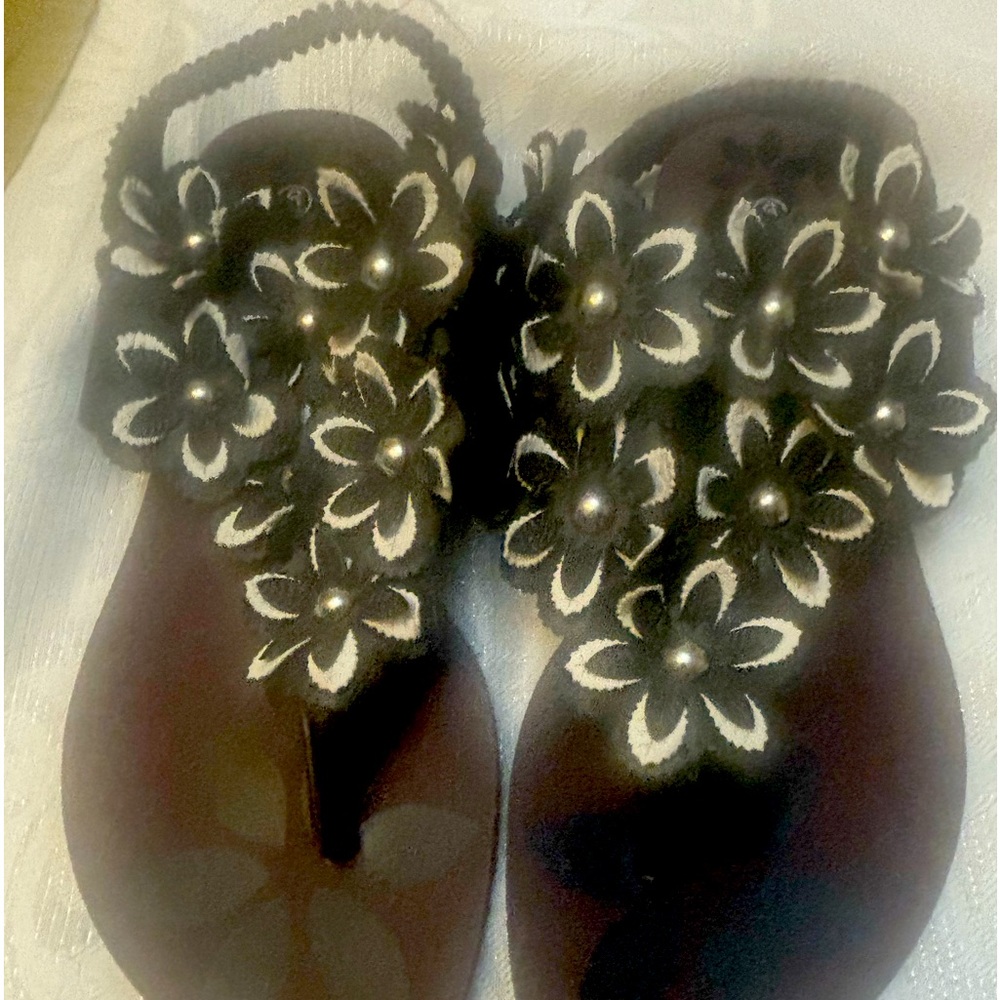Black flat sandals with floral design.   New 10